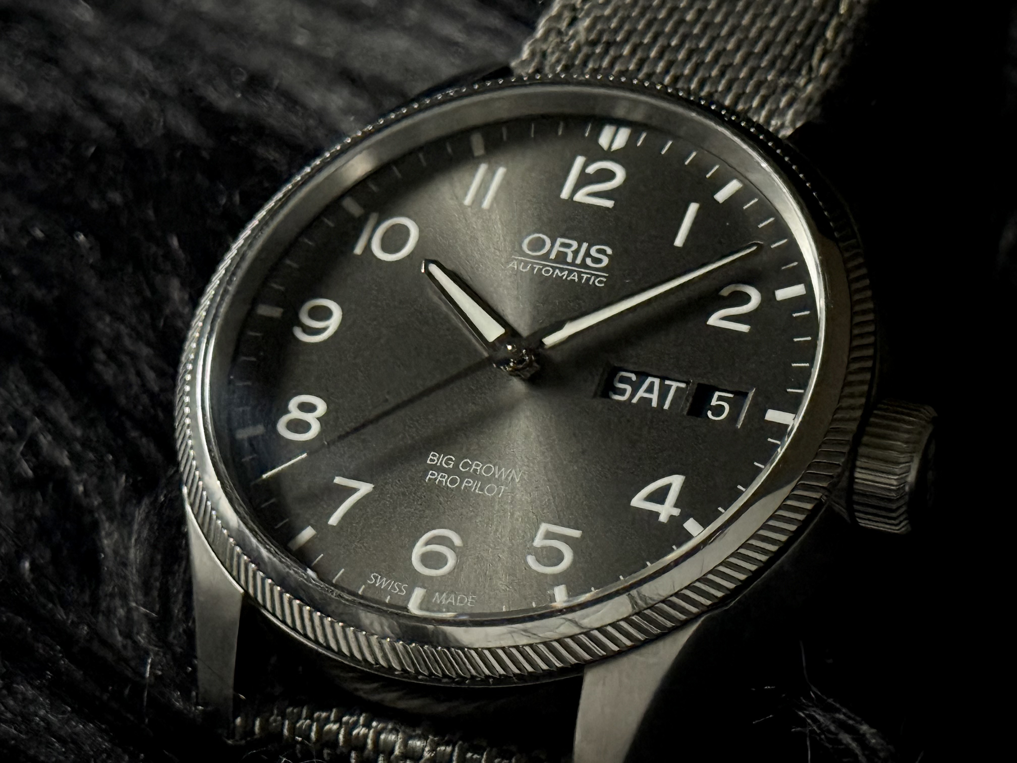 Gray dial of the Oris Big Crown ProPilot with oversized white numerals and day-date display